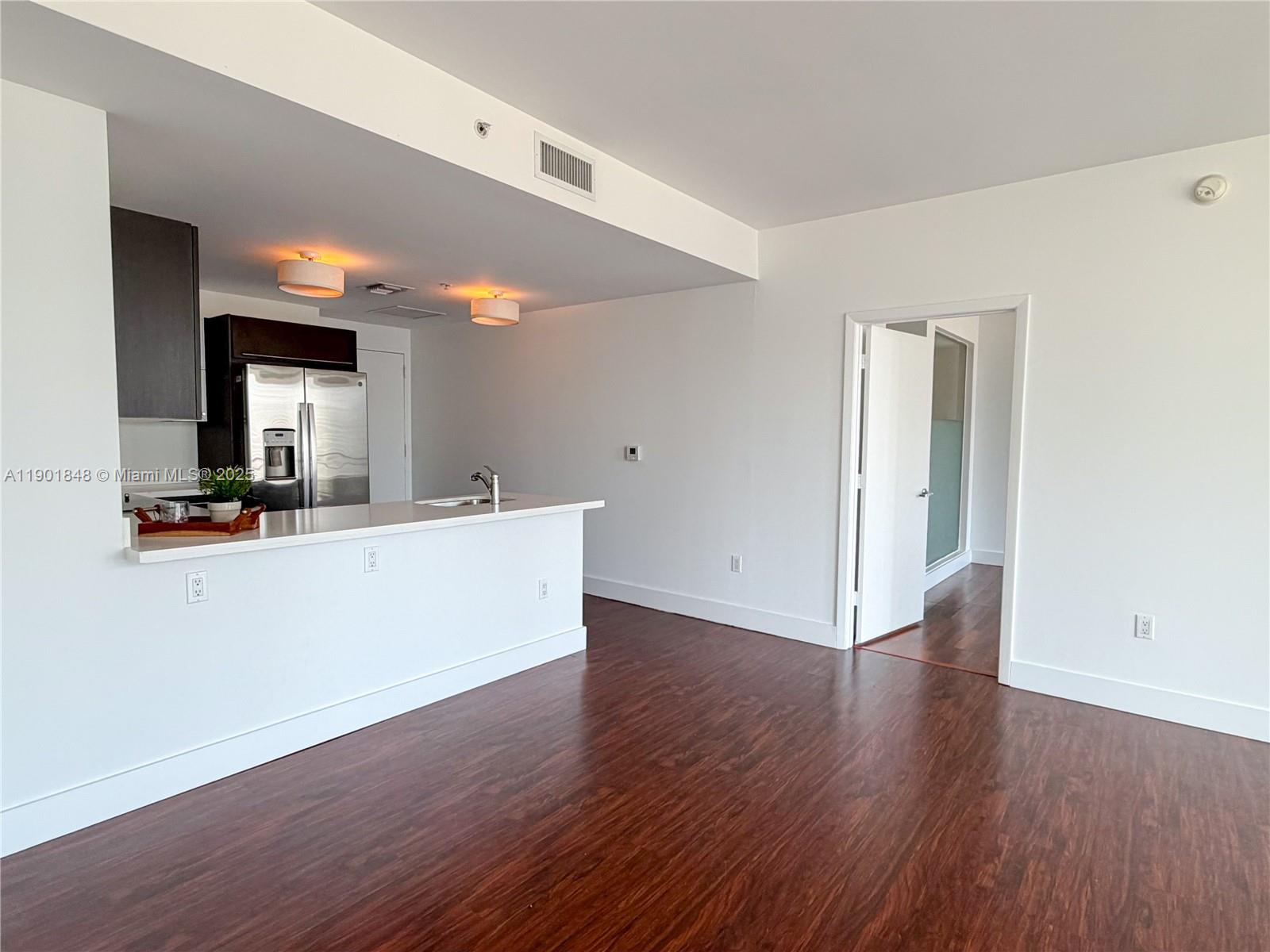 90 Southwest 3rd Street, Unit 2401 Miami, FL 33130 - Photo 15 of 68 a view of a kitchen with a sink and a mirror