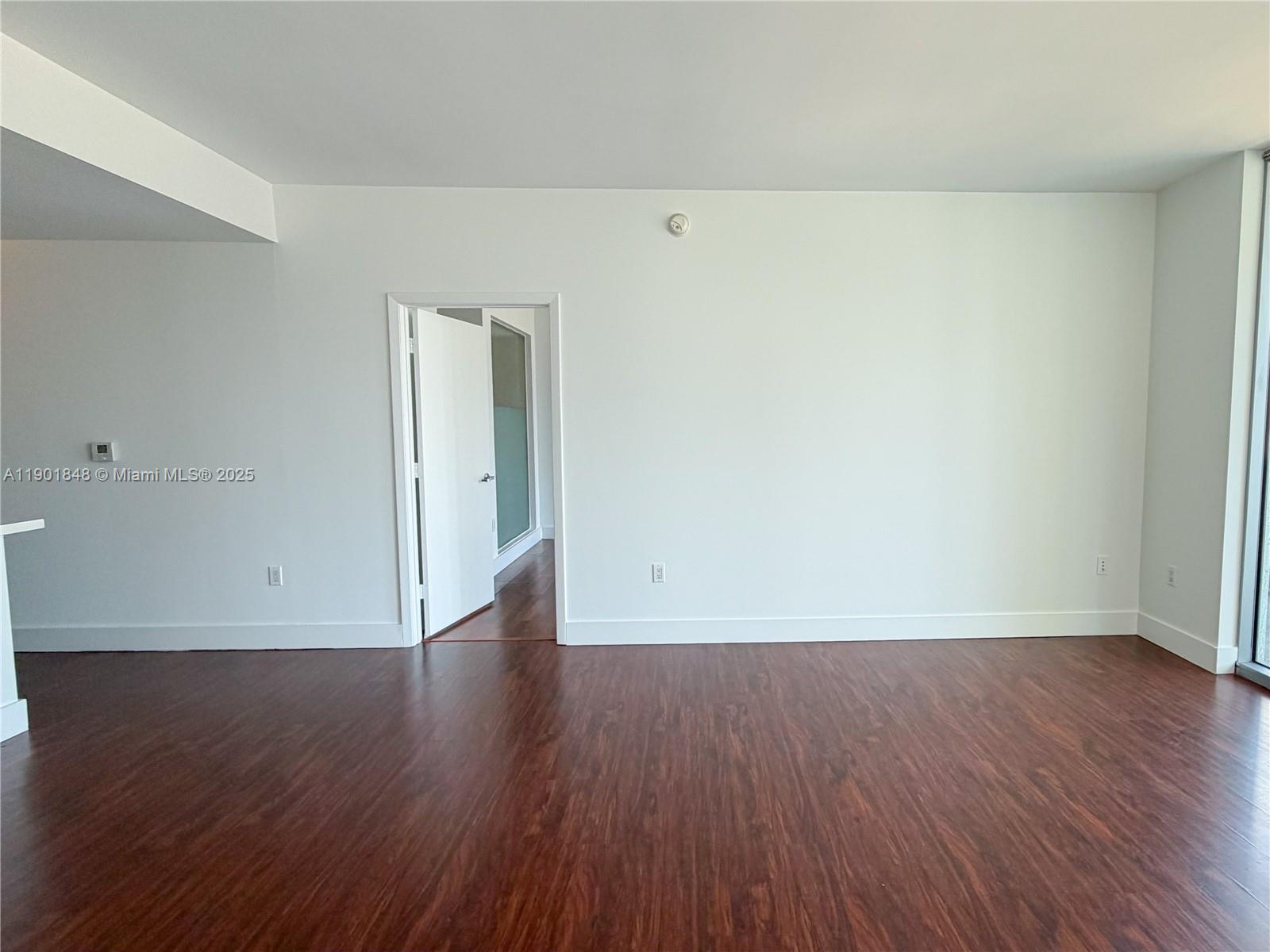90 Southwest 3rd Street, Unit 2401 Miami, FL 33130 - Photo 17 of 68 a view of an empty room with wooden floor
