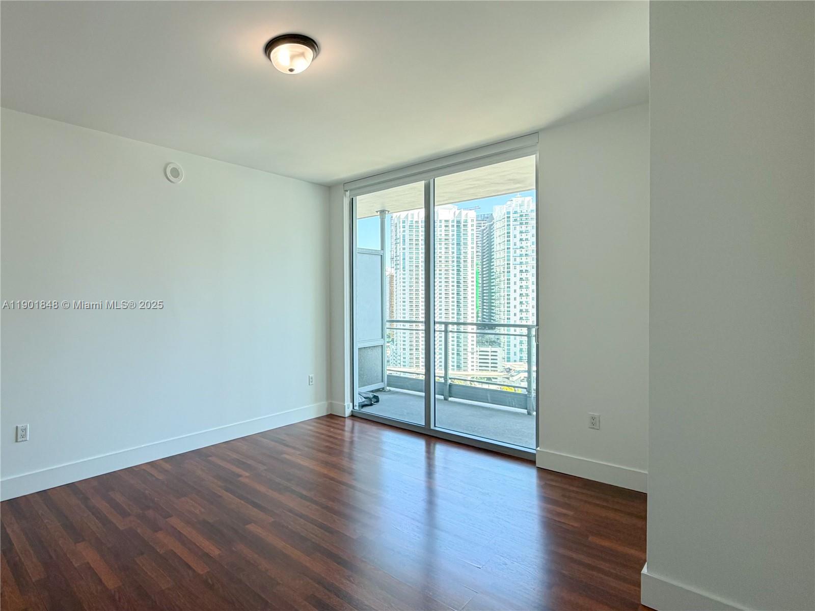 90 Southwest 3rd Street, Unit 2401 Miami, FL 33130 - Photo 18 of 68 wooden floor in an empty room with a window