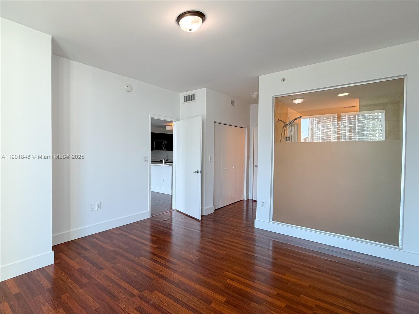 90 Southwest 3rd Street, Unit 2401 Miami, FL 33130 - Photo 19 of 68 an empty room with wooden floor and windows