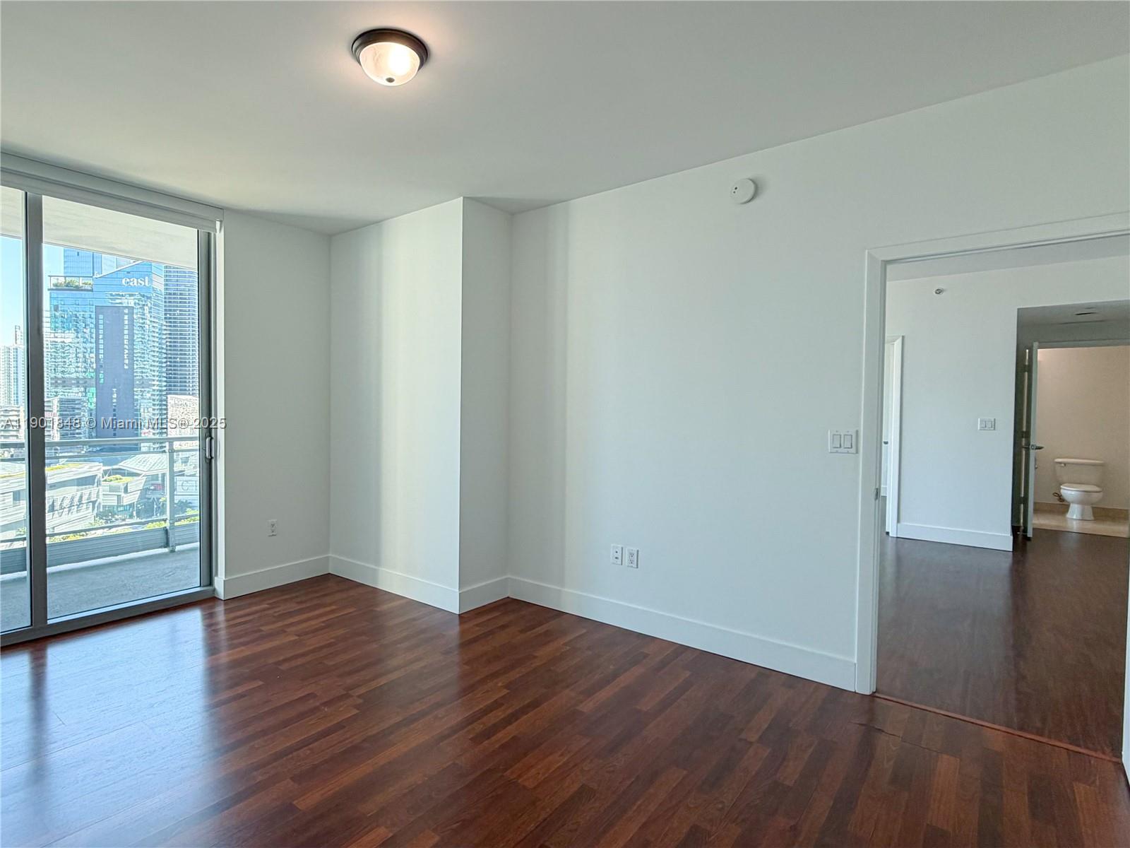 90 Southwest 3rd Street, Unit 2401 Miami, FL 33130 - Photo 20 of 68 wooden floor in an empty room with a window