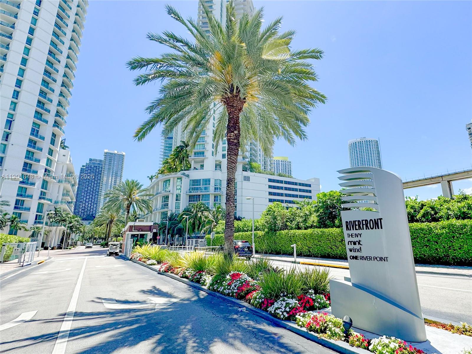 90 Southwest 3rd Street, Unit 2401 Miami, FL 33130 - Photo 2 of 68 a front view of multi story residential apartment building with yard and swimming pool