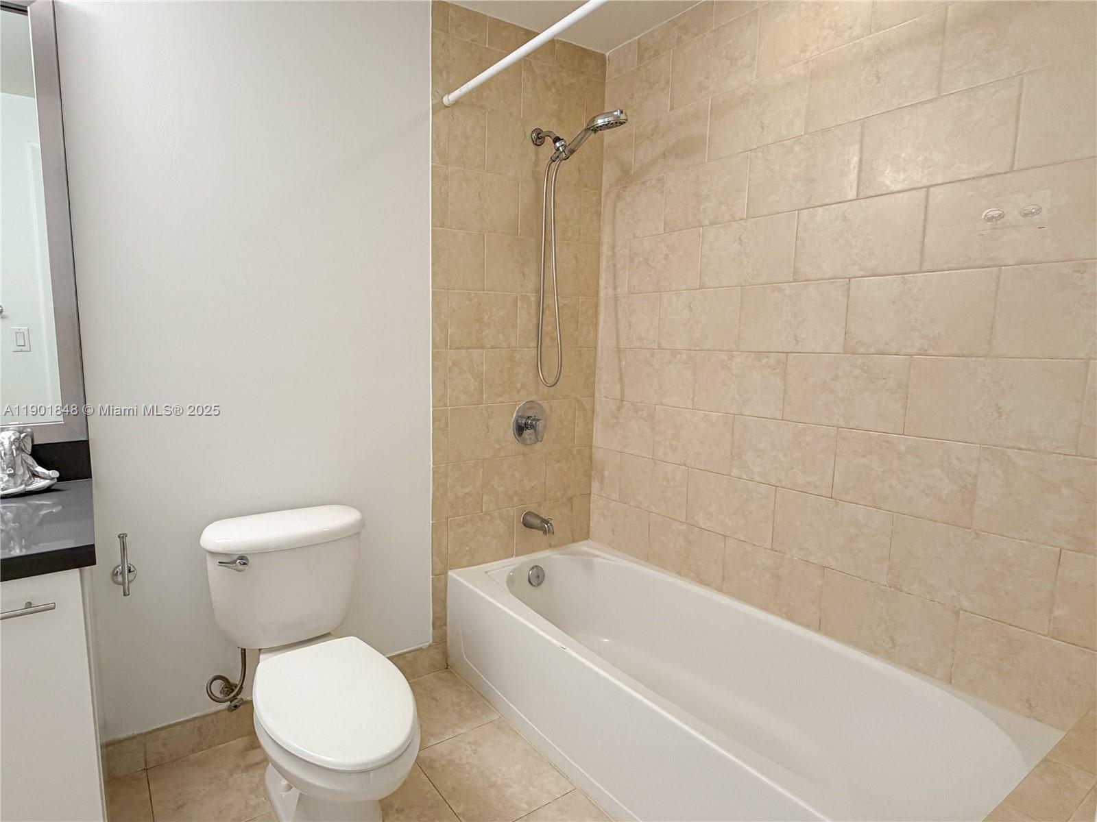 90 Southwest 3rd Street, Unit 2401 Miami, FL 33130 - Photo 37 of 68 a white toilet and a bath tub sitting next to a white sink