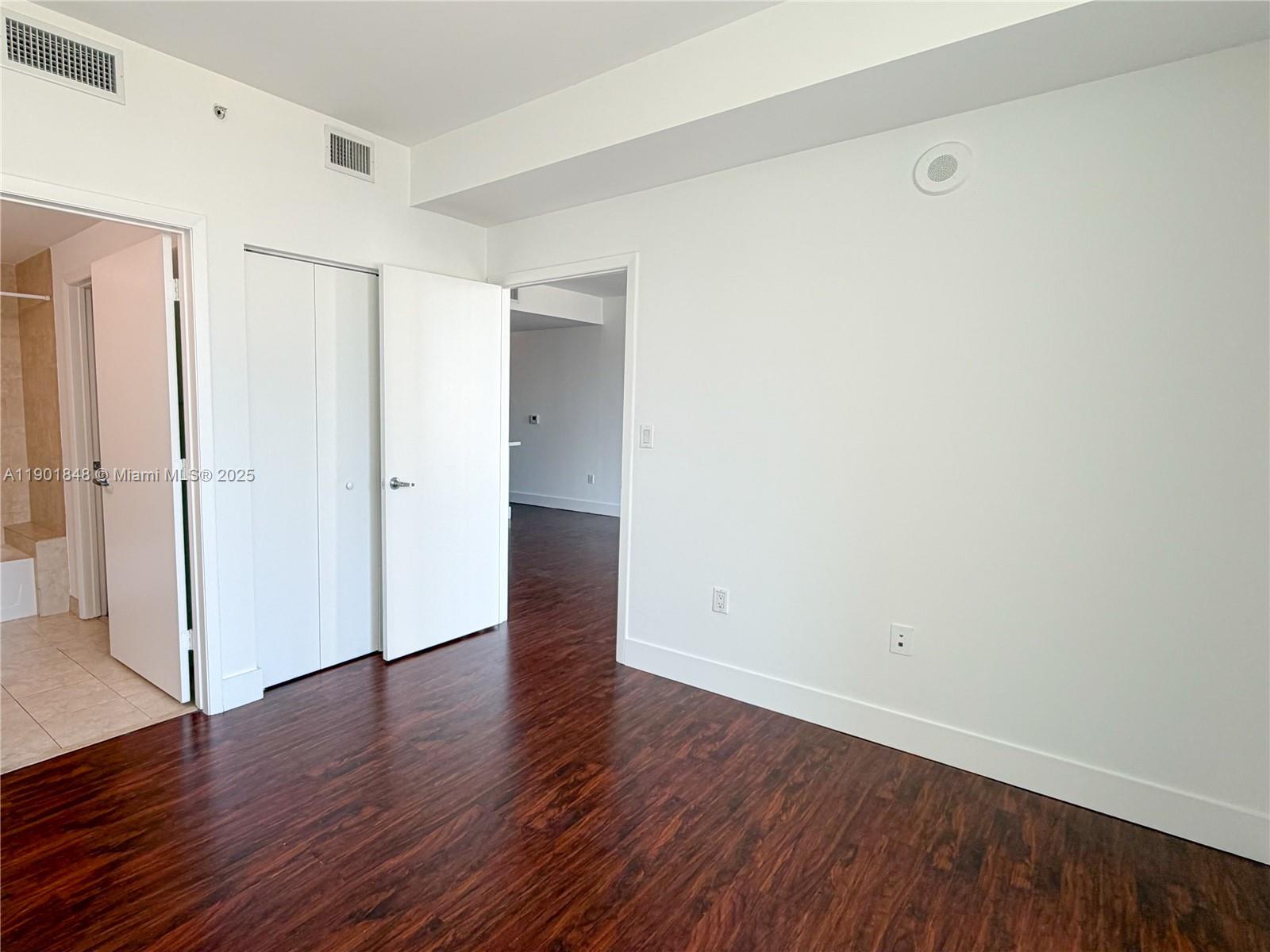 90 Southwest 3rd Street, Unit 2401 Miami, FL 33130 - Photo 43 of 68 a view of an empty room with wooden floor