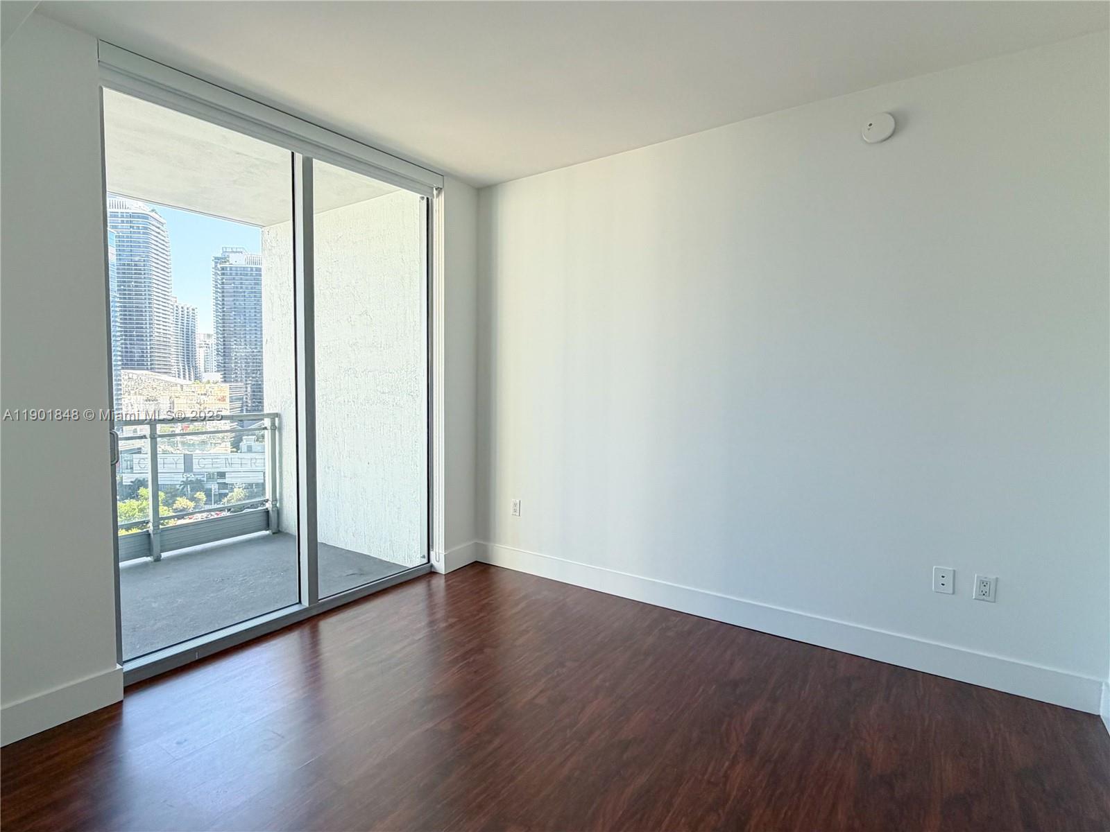 90 Southwest 3rd Street, Unit 2401 Miami, FL 33130 - Photo 44 of 68 a view of wooden floor and windows in a room
