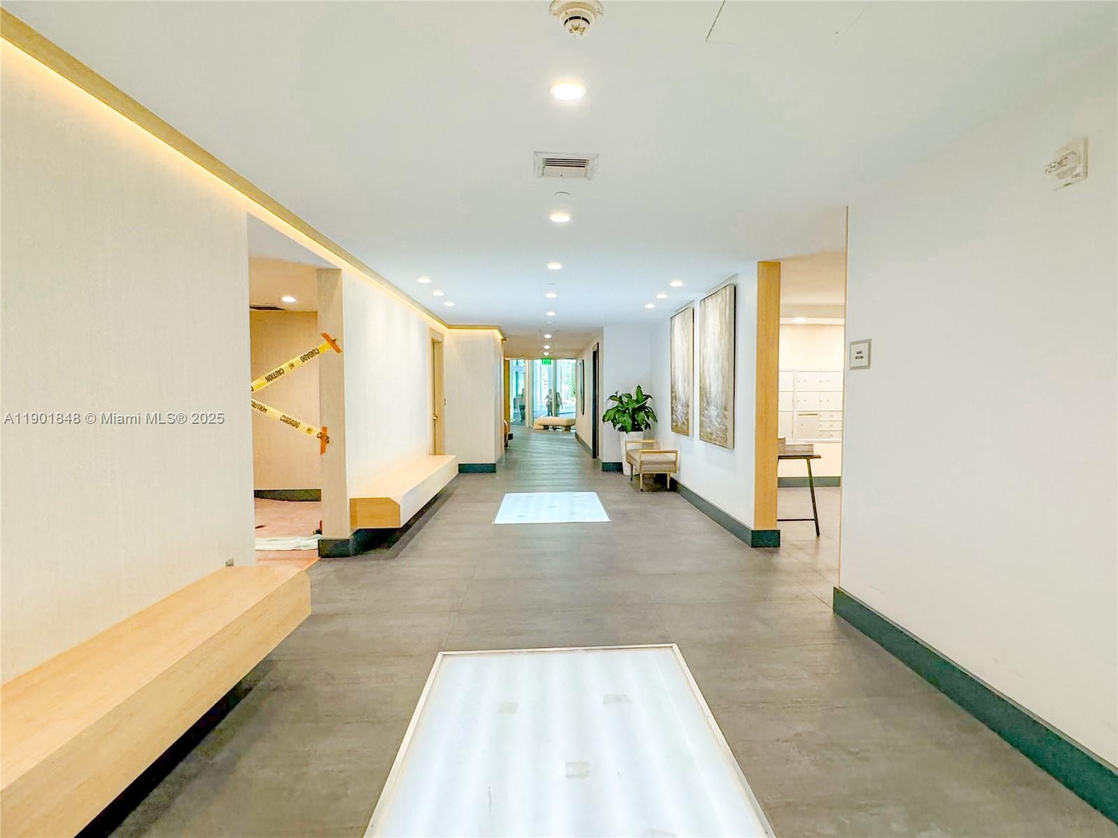 90 Southwest 3rd Street, Unit 2401 Miami, FL 33130 - Photo 59 of 68 a view of a hallway with wooden floor and a bathroom