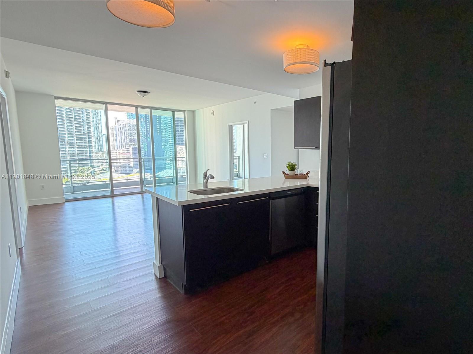 90 Southwest 3rd Street, Unit 2401 Miami, FL 33130 - Photo 6 of 68 a room with wooden floors and large windows