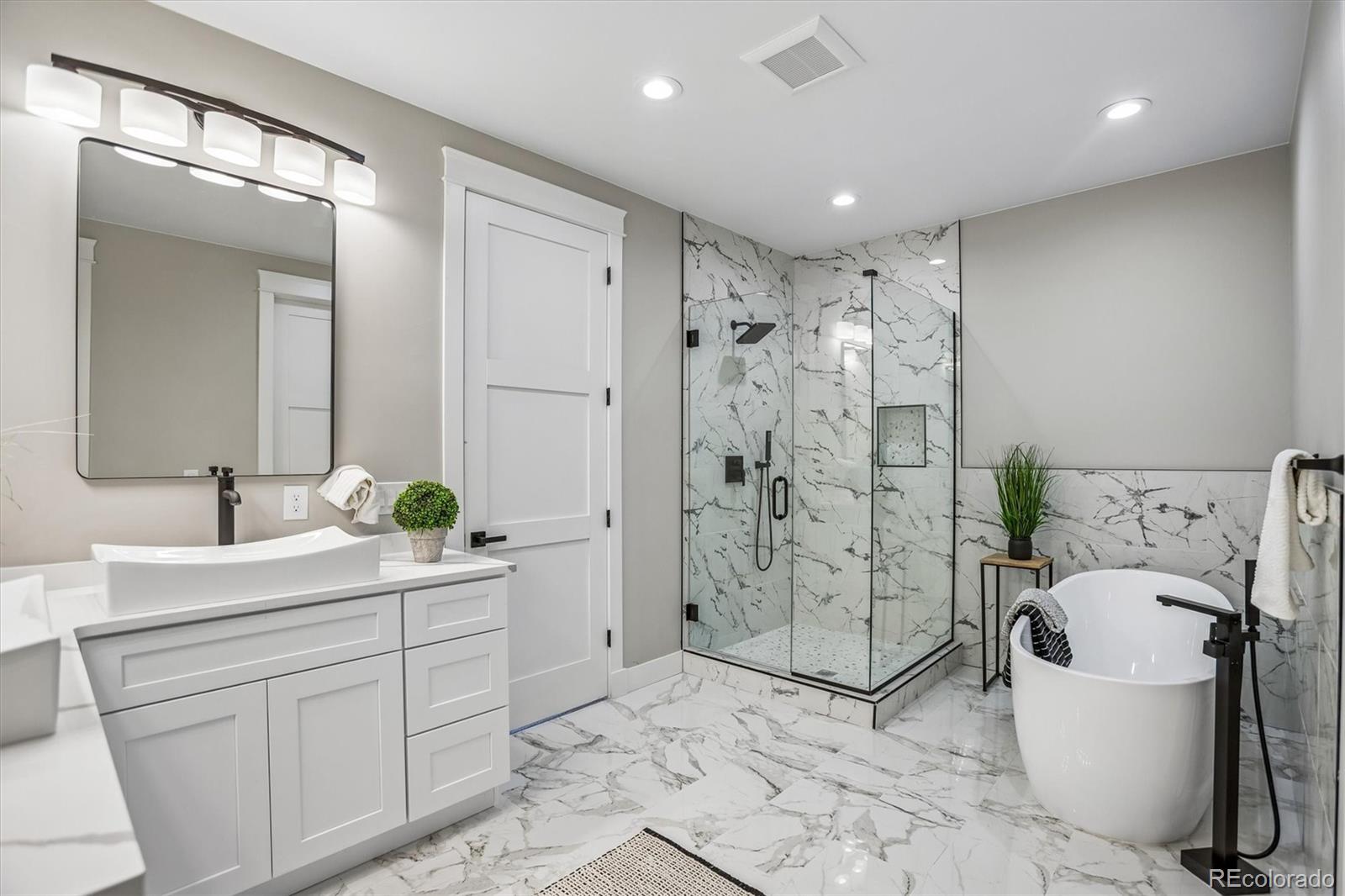 13350 Imboden Road Hudson, CO 80642 - Photo 20 of 50 a spacious bathroom with a shower sink mirror and a bathtub