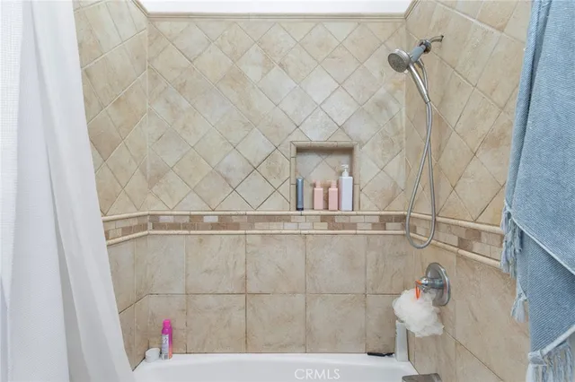 a bathroom with a bathtub and shower