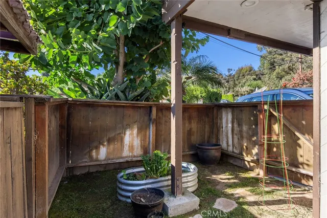 a view of a backyard with plants and outdoor seating