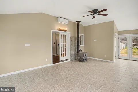 an empty room with closet and windows