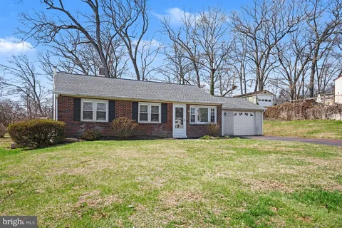 a house that has a big yard with large trees