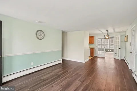 a view of a room with wooden floor