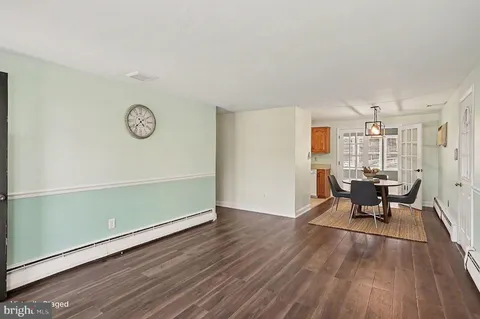 an empty room with furniture and wooden floor