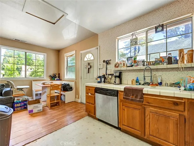 a kitchen with stainless steel appliances granite countertop sink stove top oven and cabinets