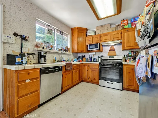 a kitchen with stainless steel appliances granite countertop a stove and a sink