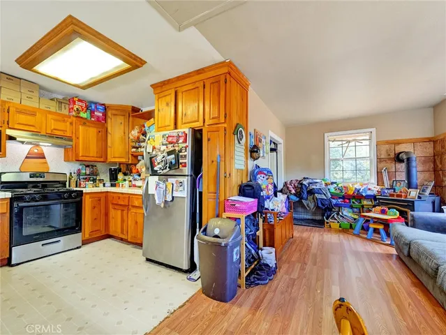 a view of a play room with toys and wooden floor