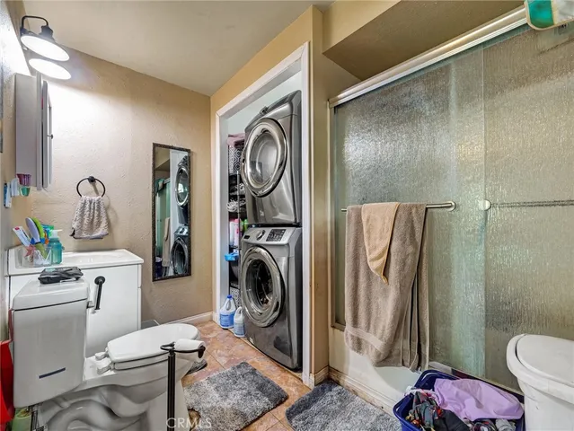 a bathroom with a sink a toilet and a shower