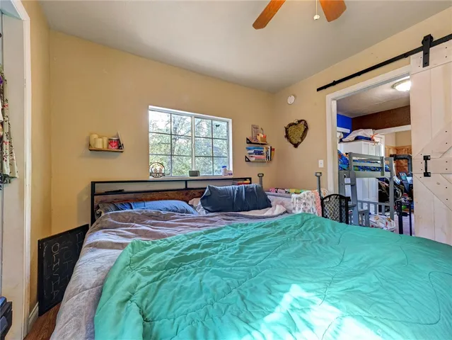 a bedroom with a bed and a large window