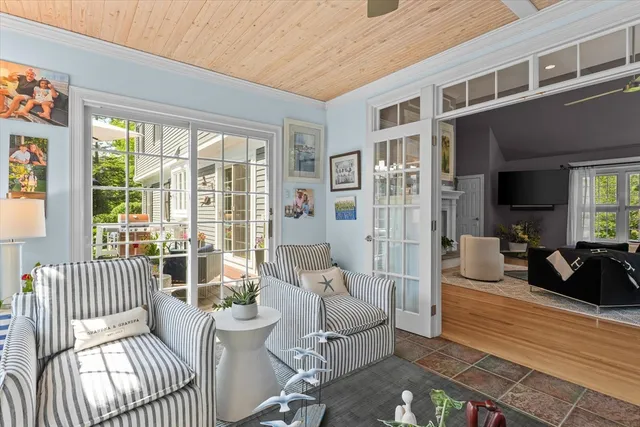 a living room with furniture and a floor to ceiling window