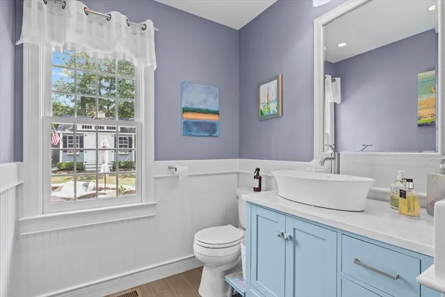 a bathroom with a sink a toilet and a window