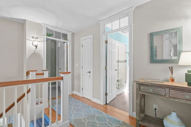 a very nice looking room with wooden floor and a bathroom