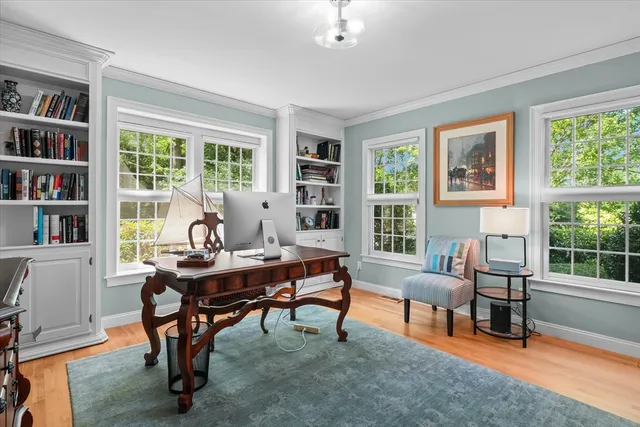 a view of a workspace with a window and lounge chair