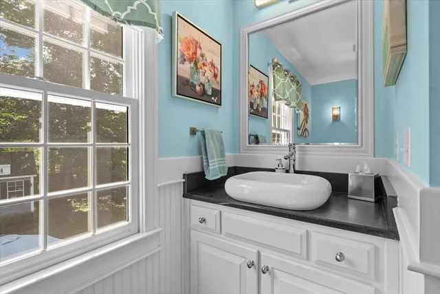 a bathroom with a granite countertop sink and a mirror