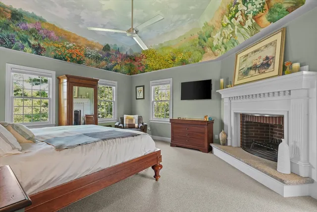 a spacious bedroom with a bed and a fireplace