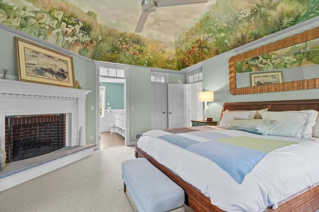 a spacious bedroom with a bed and a fireplace