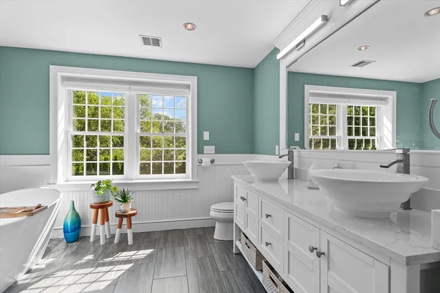 a dining room with furniture and a potted plant