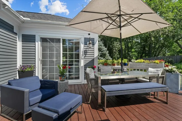 a view of a patio with a dining table and chairs under an umbrella