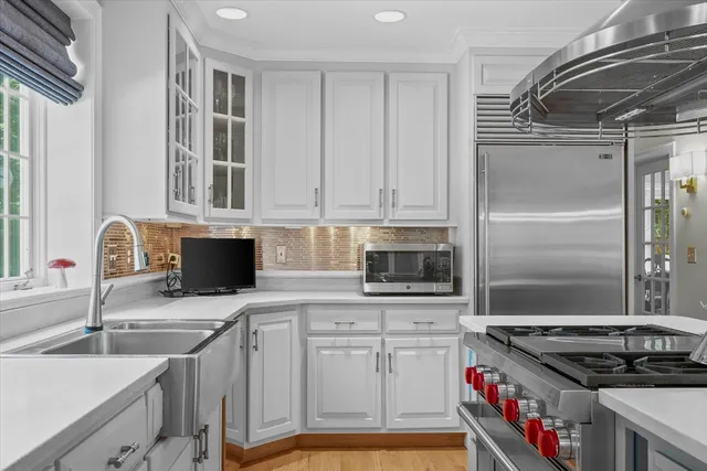 a kitchen with stainless steel appliances granite countertop a sink stove and cabinets