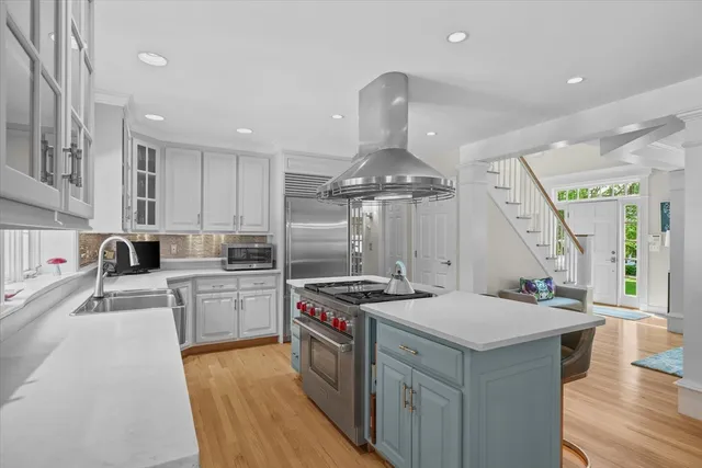 a kitchen that has a lot of cabinets a sink and a stove in it