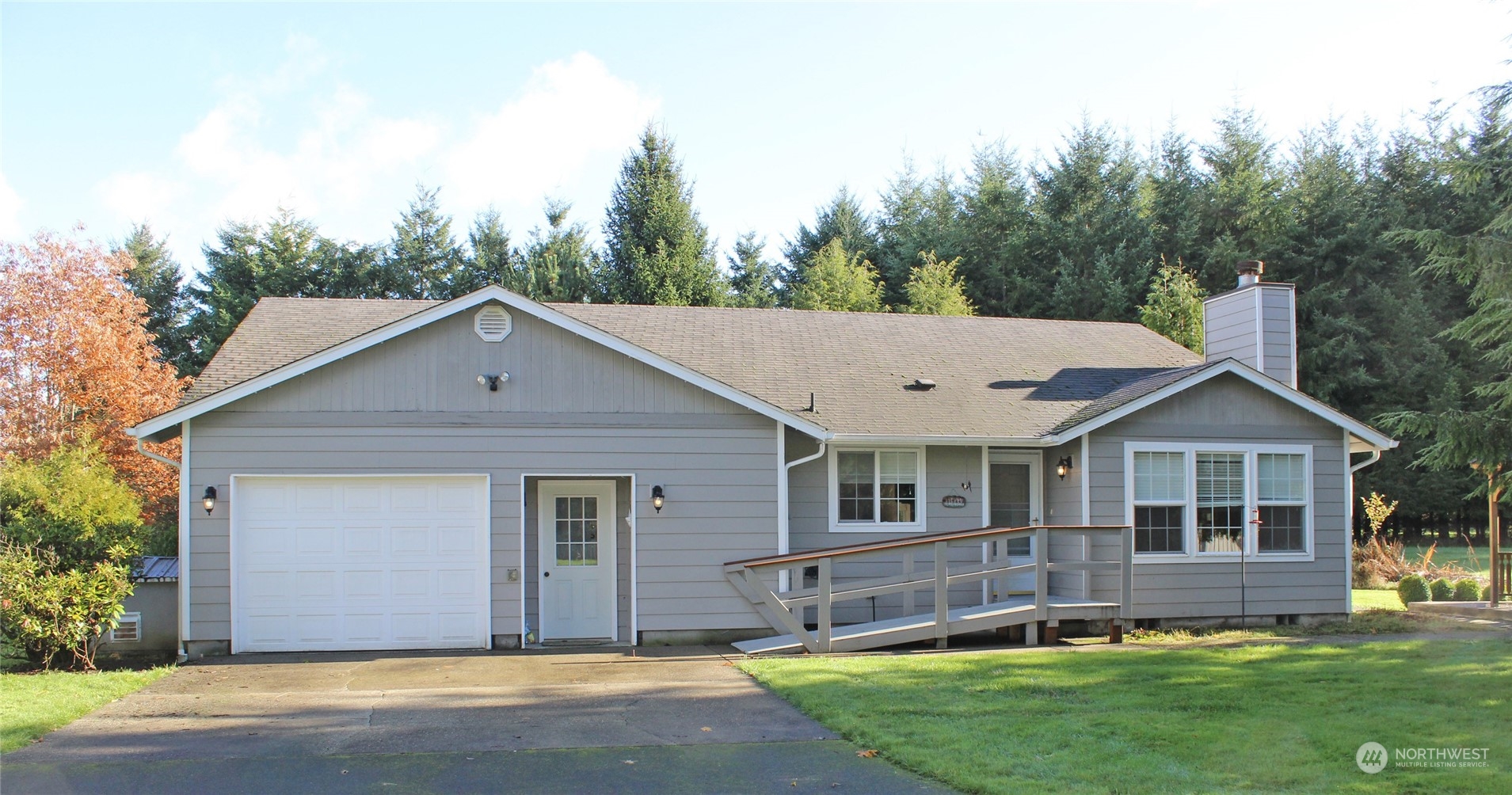 9441 Gastaeson Lane Southwest Rochester, WA 98579 - Photo 1 of 40 a view of a yard in front of a house with large windows