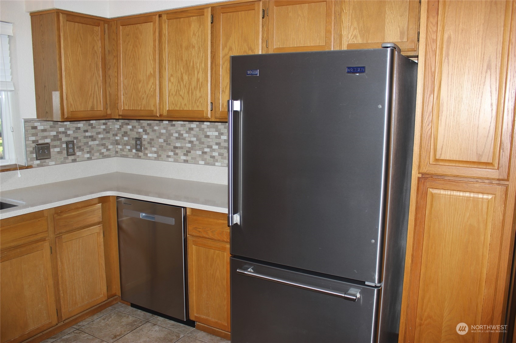 9441 Gastaeson Lane Southwest Rochester, WA 98579 - Photo 17 of 40 a kitchen with a refrigerator and cabinets