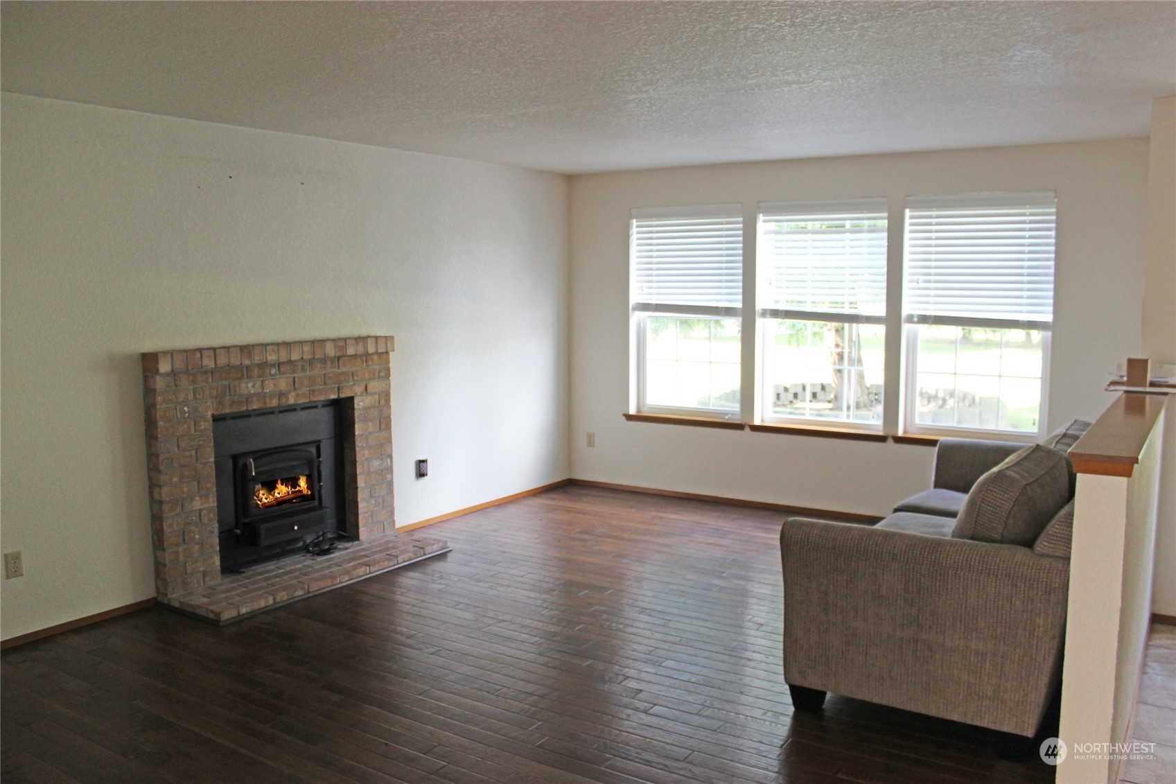9441 Gastaeson Lane Southwest Rochester, WA 98579 - Photo 19 of 40 a living room with furniture and a fireplace