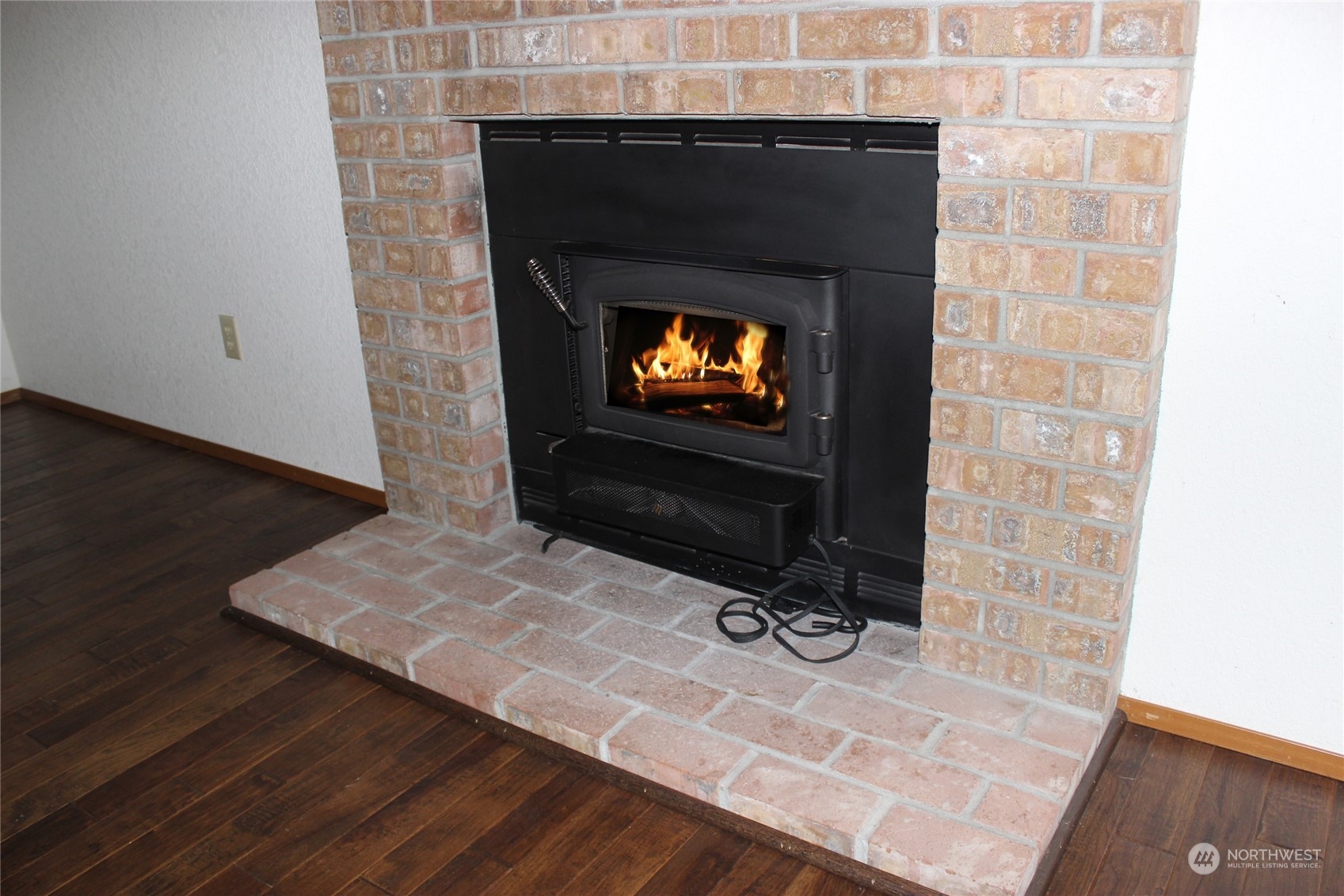 9441 Gastaeson Lane Southwest Rochester, WA 98579 - Photo 20 of 40 a living room with a fireplace and a flat screen tv
