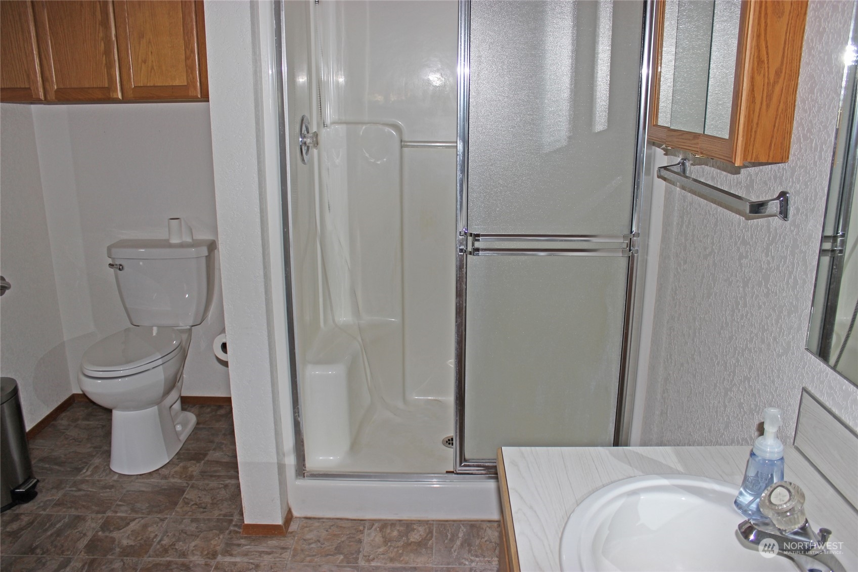 9441 Gastaeson Lane Southwest Rochester, WA 98579 - Photo 22 of 40 a bathroom with a granite countertop toilet and a sink