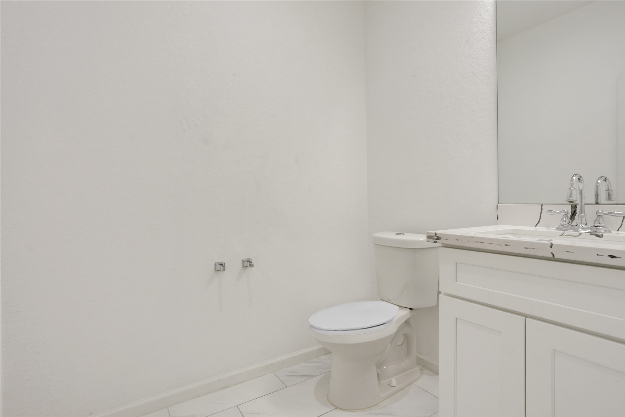 5317 Chennault Road, Unit A / B Houston, TX 77033 - Photo 16 of 27 a bathroom with a sink a toilet and a mirror