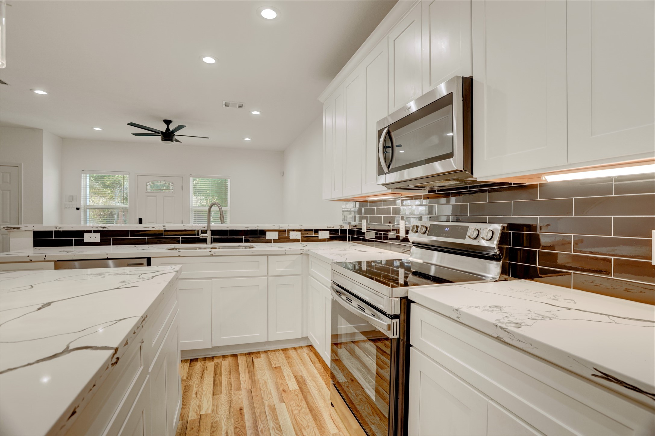 5317 Chennault Road, Unit A / B Houston, TX 77033 - Photo 23 of 27 a kitchen that has a sink and a stove top oven