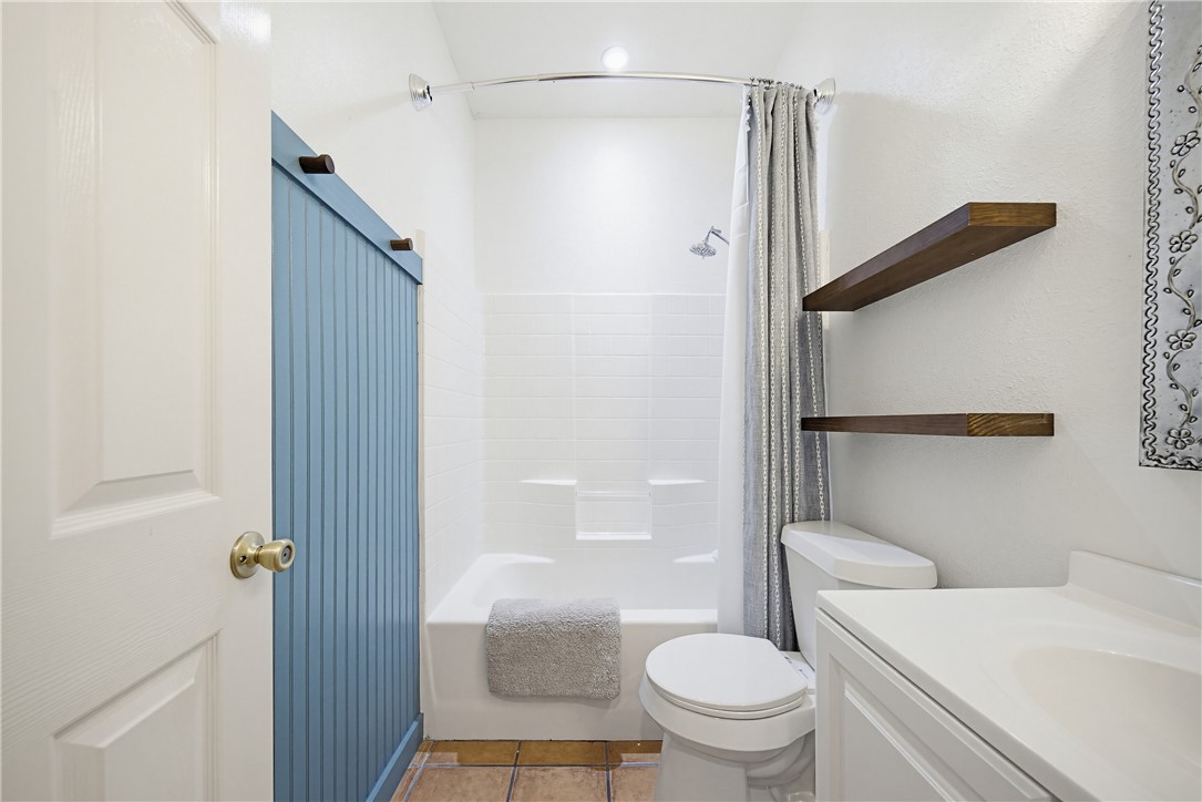 7251 Prairie Drive, Unit 6 Corpus Christi, TX 78413 - Photo 18 of 28 a bathroom with a toilet and a shower