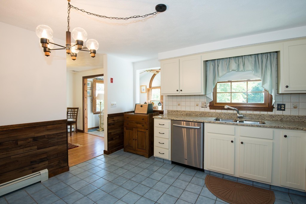132 Spring Street Stoneham, MA 02180 - Photo 16 of 30 a kitchen with a sink stove and cabinets