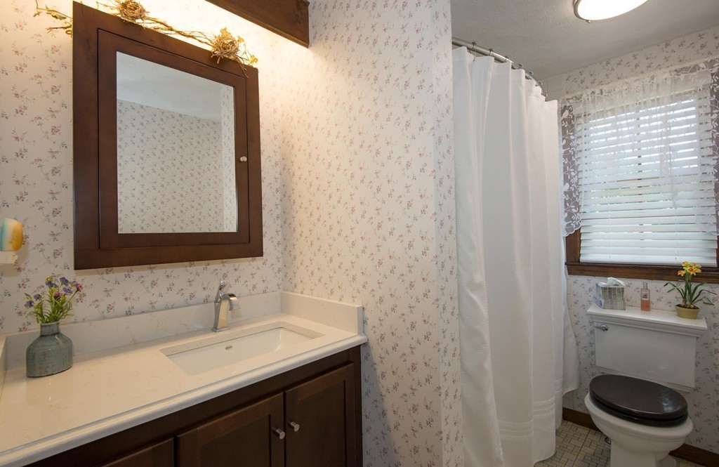 132 Spring Street Stoneham, MA 02180 - Photo 17 of 30 a bathroom with a sink a toilet and mirror