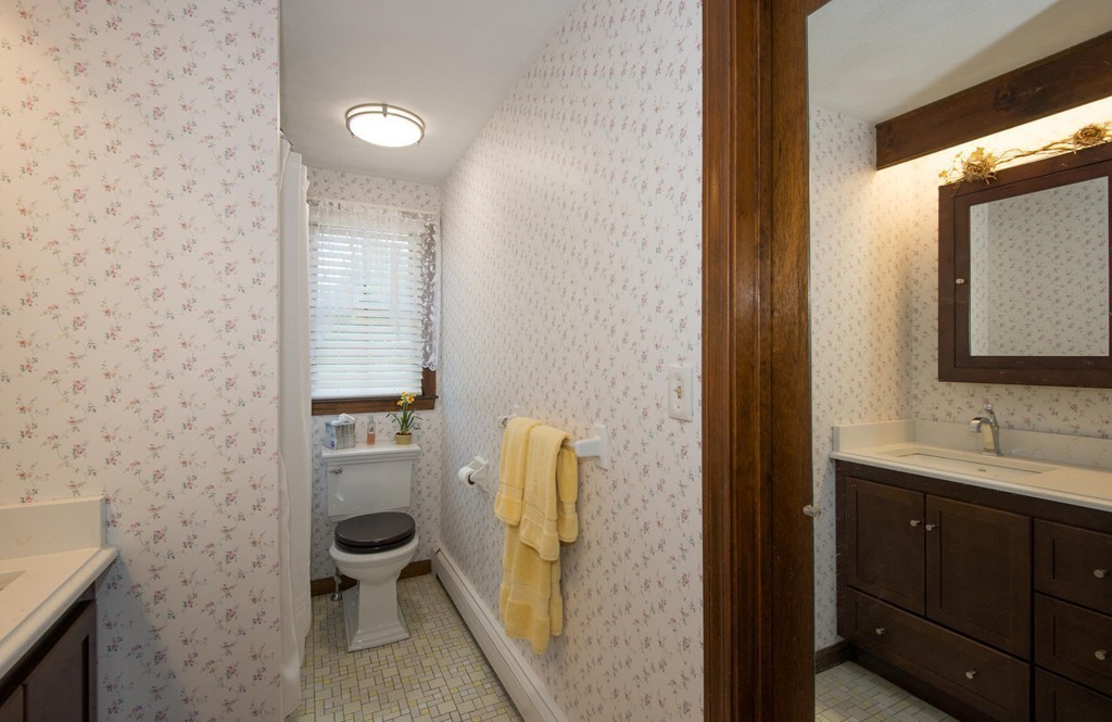 132 Spring Street Stoneham, MA 02180 - Photo 18 of 30 a bathroom with a sink and a mirror