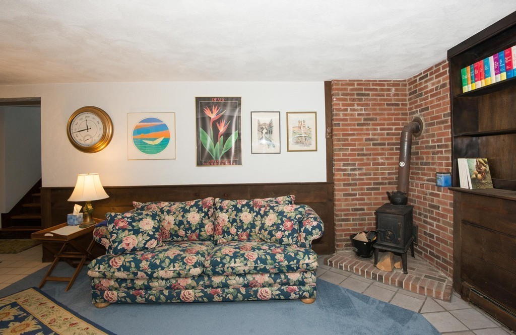 132 Spring Street Stoneham, MA 02180 - Photo 27 of 30 a bedroom with a bed and a chair