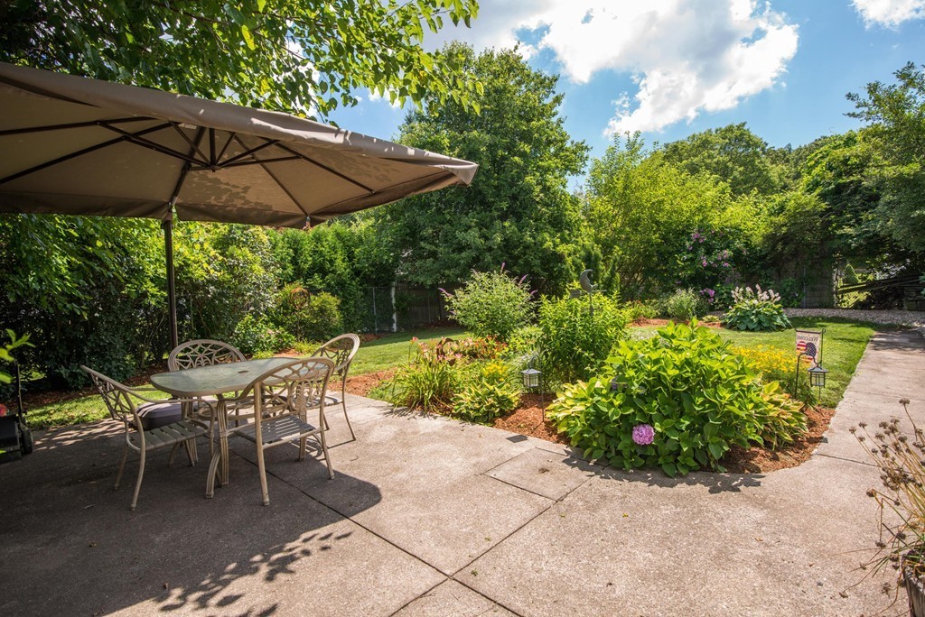 132 Spring Street Stoneham, MA 02180 - Photo 29 of 30 a patio with a yard table and chairs