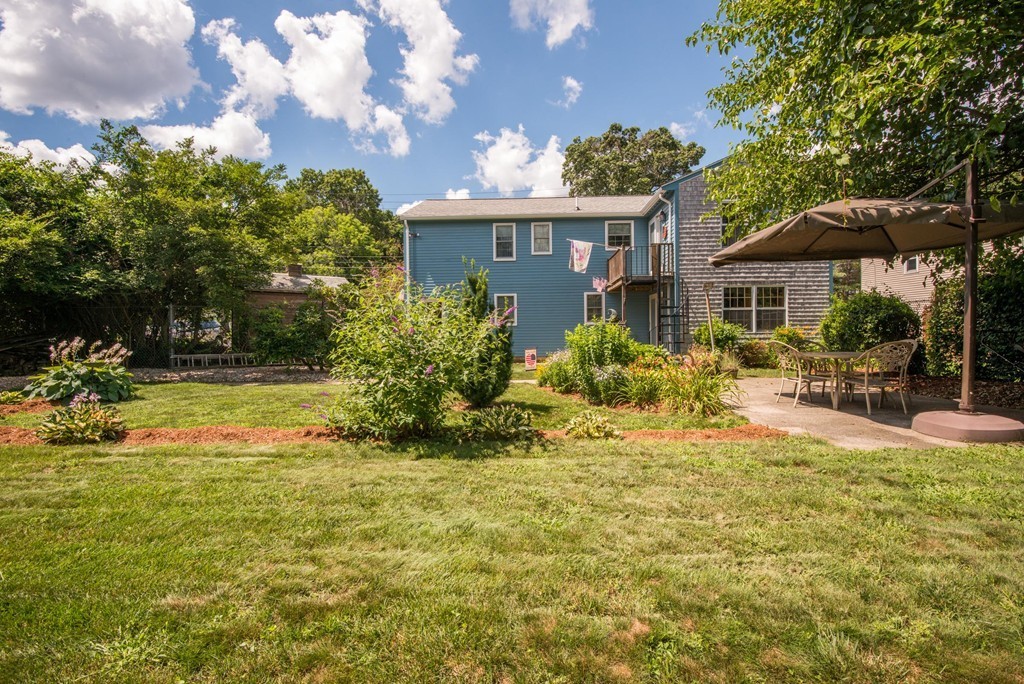 132 Spring Street Stoneham, MA 02180 - Photo 30 of 30 a view of a house with swimming pool and sitting area