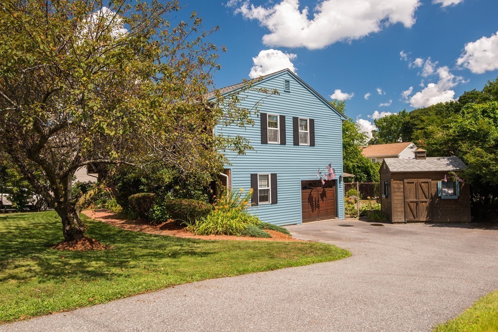 132 Spring Street Stoneham, MA 02180 - Photo 3 of 30 a front view of a house with a yard and garage