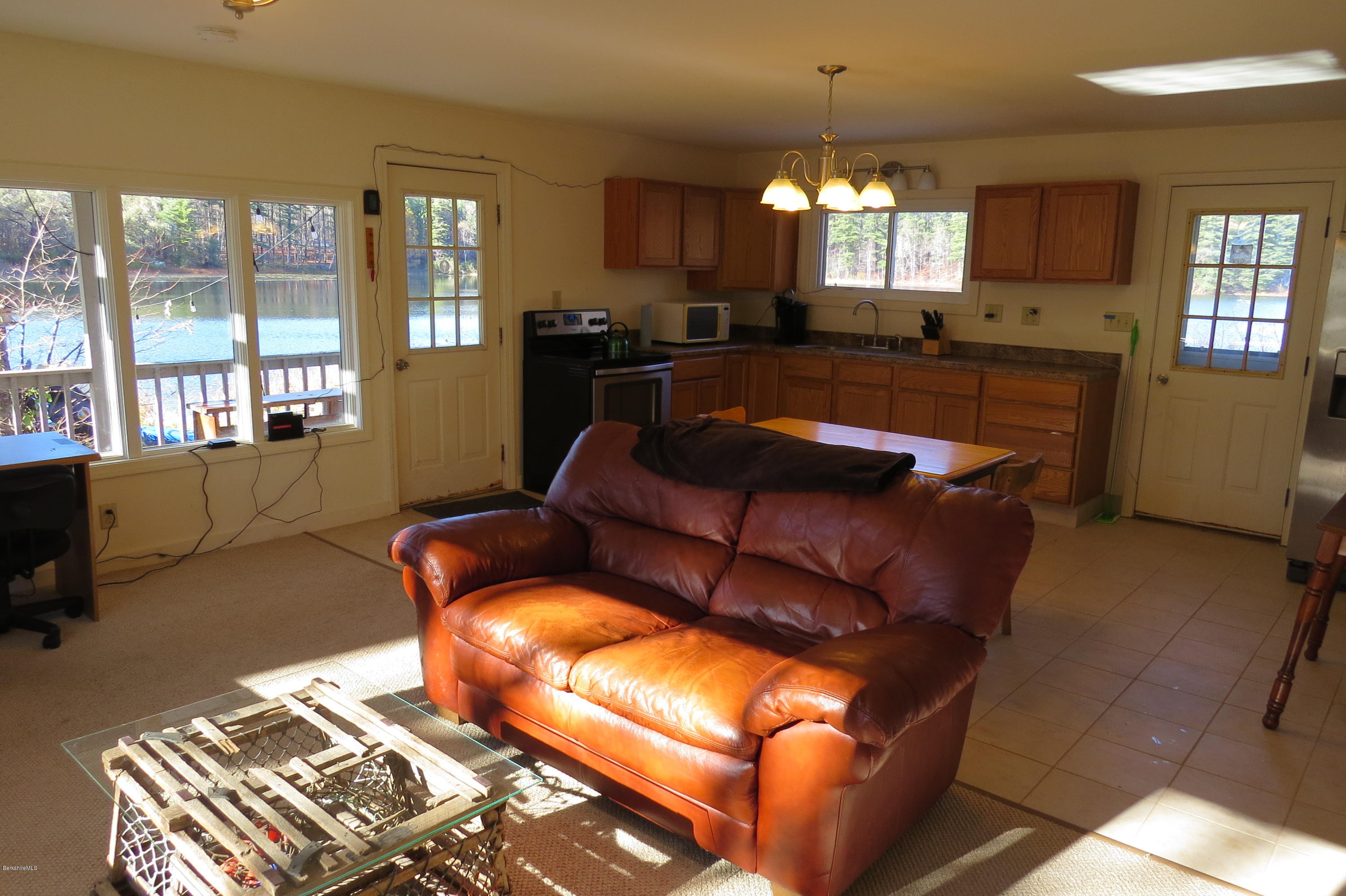 1601 Barber Pond Road Pownal, VT 05261 - Photo 11 of 34 a living room with furniture and a chandelier
